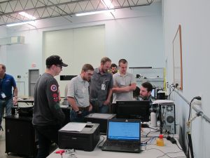 6 men looking at a computer screen for the Mass Properties Measurement and Calculation Seminar