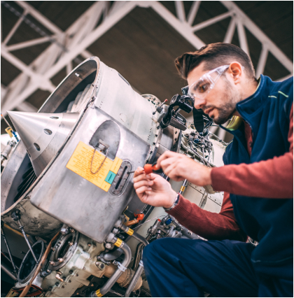 Male engineer using a screwdriver to tighten a turbine